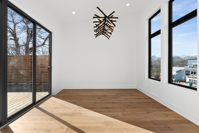 unfurnished room with hardwood / wood-style floors