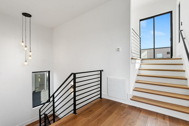 stairs featuring wood-type flooring