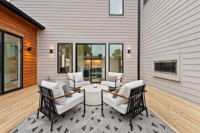 view of patio featuring a wooden deck and an outdoor living space