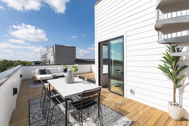 wooden terrace featuring outdoor lounge area