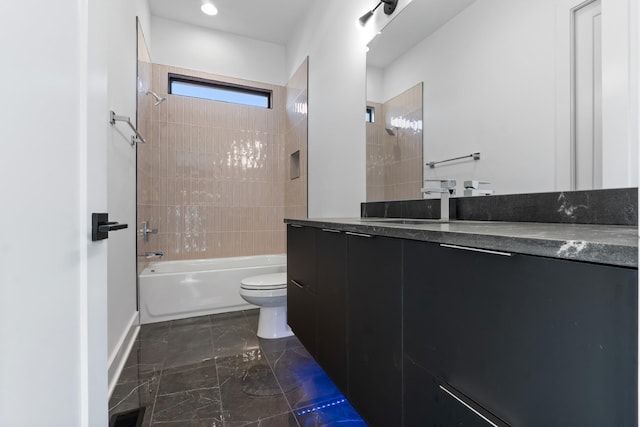 full bathroom featuring vanity, toilet, and tiled shower / bath