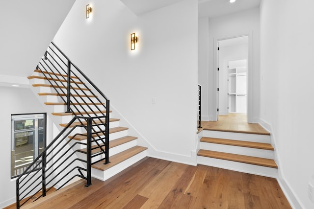 stairs with hardwood / wood-style floors