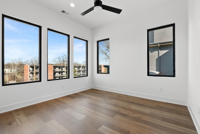 unfurnished room with hardwood / wood-style floors and ceiling fan