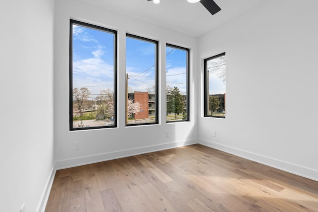 empty room with light wood-type flooring and ceiling fan