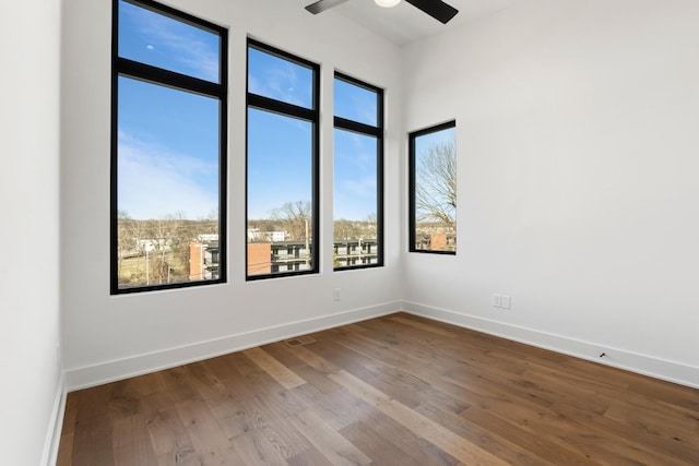 unfurnished room with hardwood / wood-style flooring and ceiling fan