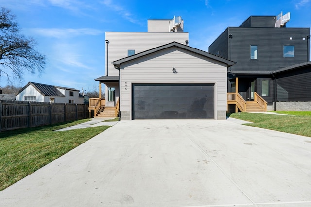 view of front of house featuring a garage and a front lawn