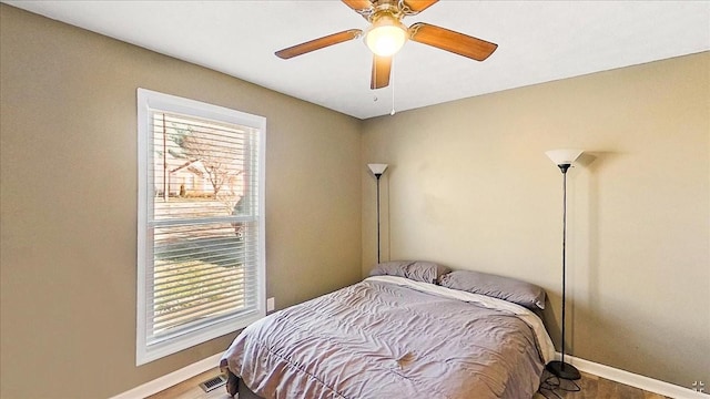 bedroom featuring hardwood / wood-style flooring and ceiling fan