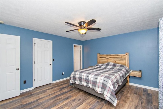 bedroom featuring a textured ceiling, dark hardwood / wood-style flooring, and ceiling fan