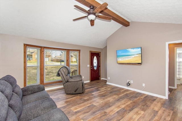 living room featuring hardwood / wood-style floors, lofted ceiling with beams, and ceiling fan