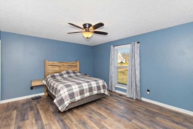 bedroom featuring ceiling fan and dark wood-type flooring