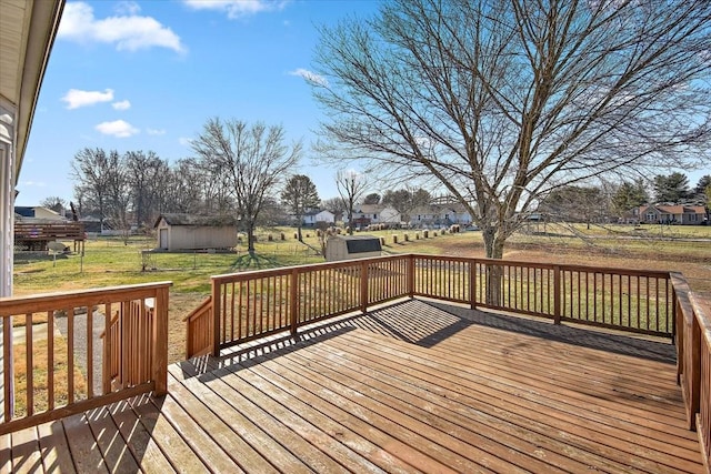 wooden deck with a lawn and a shed