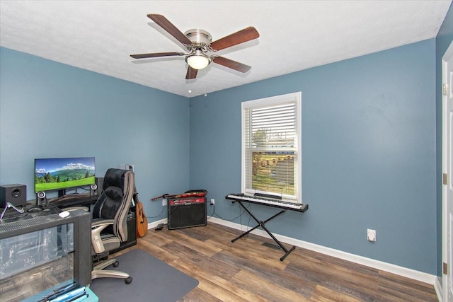 home office with hardwood / wood-style flooring and ceiling fan