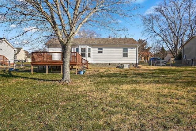 back of property with a yard and a wooden deck