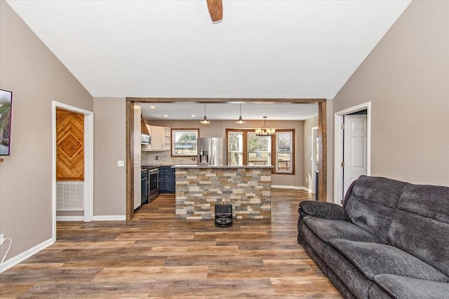 living room with hardwood / wood-style flooring and vaulted ceiling