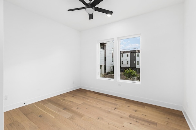 unfurnished room with ceiling fan and hardwood / wood-style floors