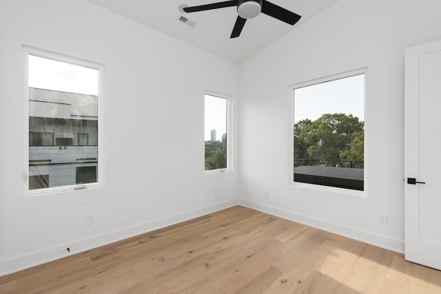 spare room featuring light hardwood / wood-style floors, lofted ceiling, and ceiling fan