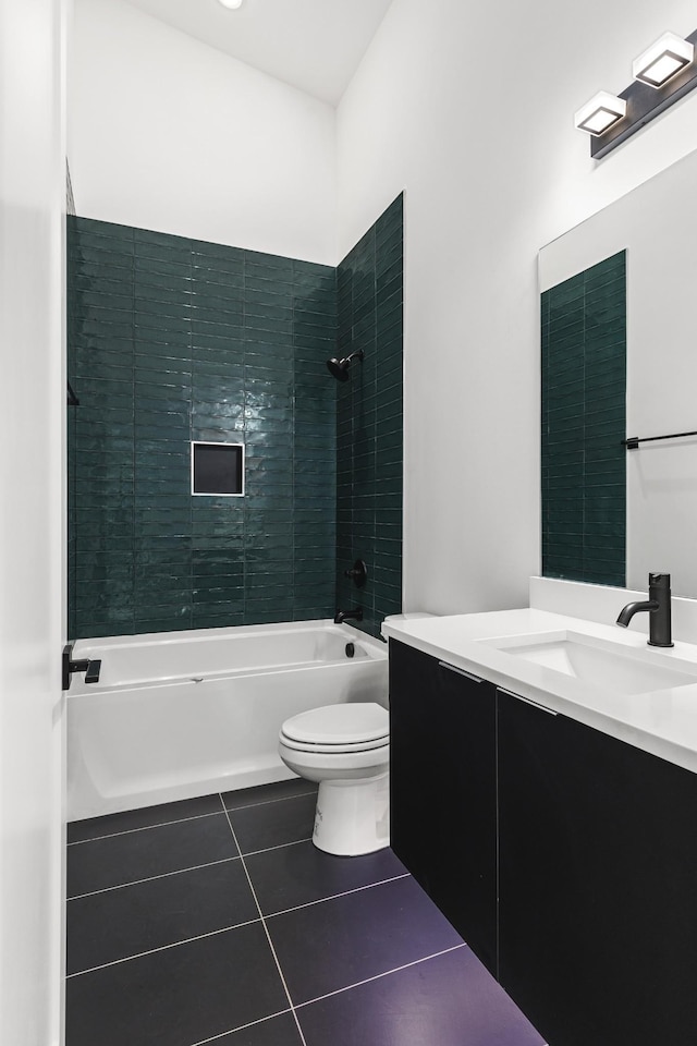 full bathroom with toilet, tile patterned floors, vanity, and tiled shower / bath