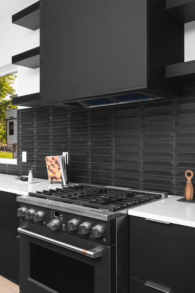 kitchen featuring decorative backsplash and high end range