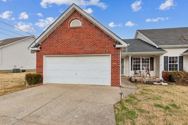 front facade with a porch, central AC unit, a garage, and a front lawn