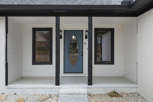 view of exterior entry with covered porch