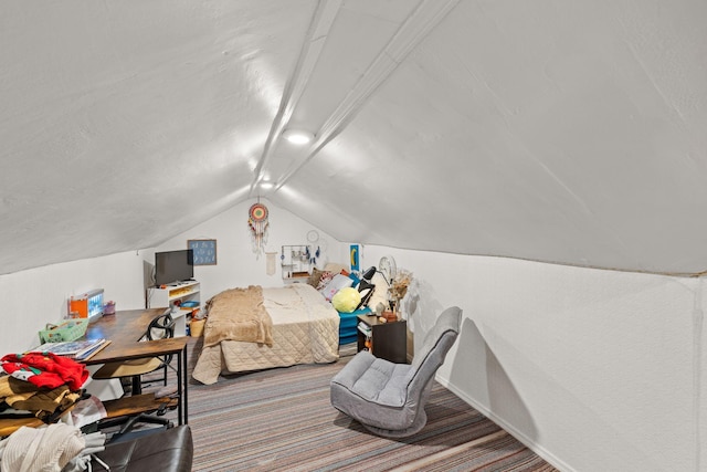 bedroom featuring carpet and vaulted ceiling