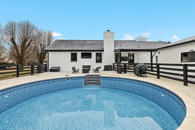 view of swimming pool with area for grilling and a patio