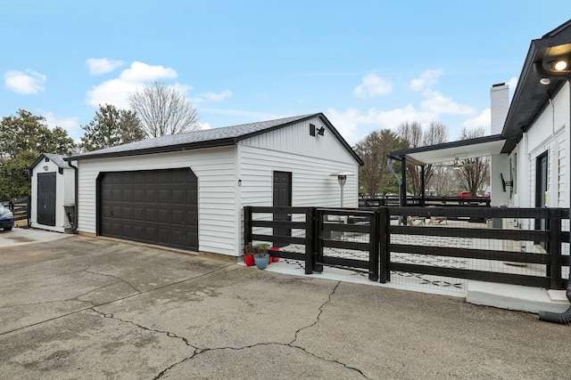 view of property exterior featuring an outbuilding and a garage