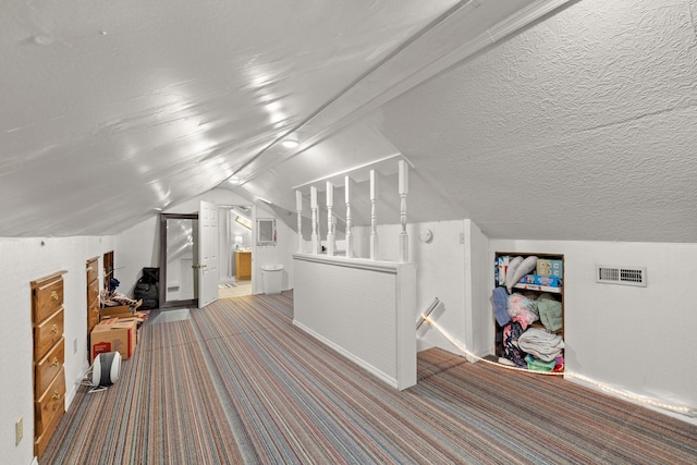 bonus room with light colored carpet, a textured ceiling, and vaulted ceiling