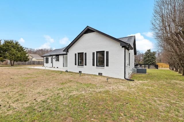 rear view of house featuring a yard