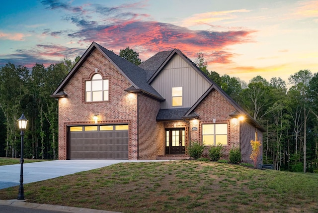 view of property with a garage and a yard