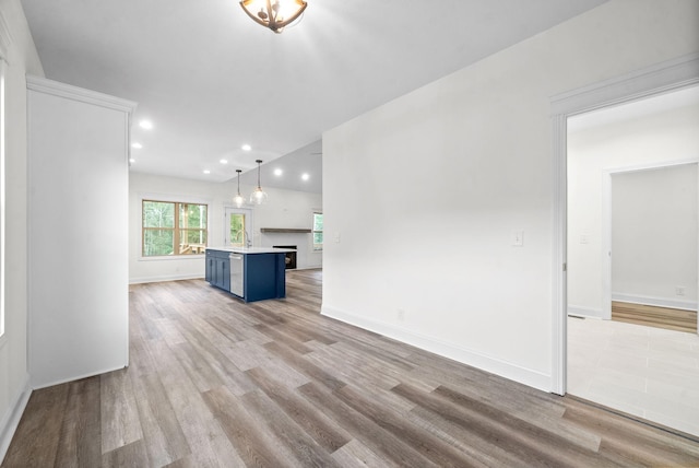 unfurnished living room featuring light hardwood / wood-style floors and sink