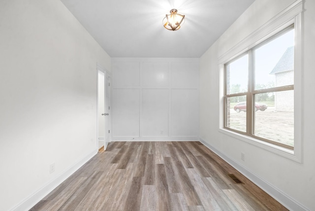 unfurnished room with light wood-type flooring