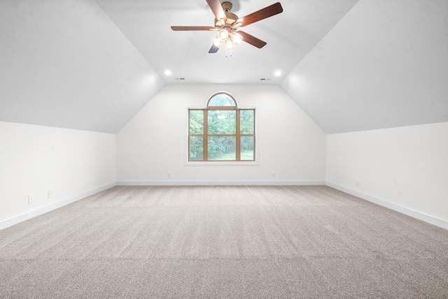 additional living space featuring ceiling fan, light colored carpet, and lofted ceiling