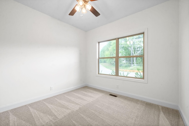 carpeted spare room with ceiling fan