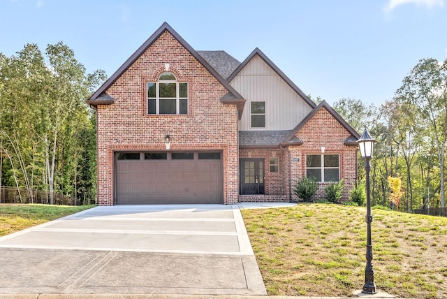 view of property with a garage and a front lawn