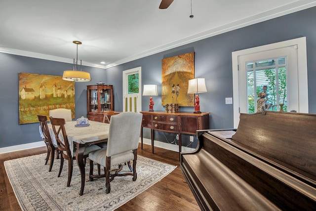 dining room with ceiling fan, dark wood-type flooring, and ornamental molding