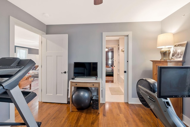 exercise area with ceiling fan and hardwood / wood-style flooring