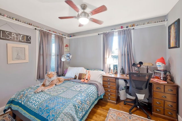 bedroom with ceiling fan and hardwood / wood-style floors