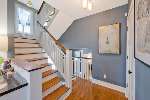 staircase featuring hardwood / wood-style floors