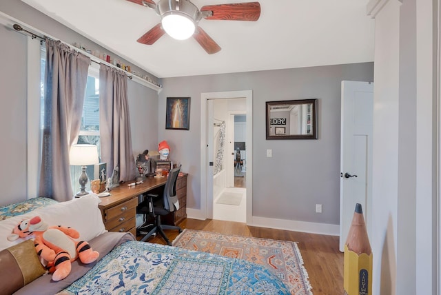 bedroom with ceiling fan, light hardwood / wood-style floors, and connected bathroom