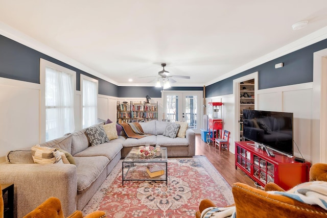 living room with french doors, ceiling fan, ornamental molding, and wood-type flooring