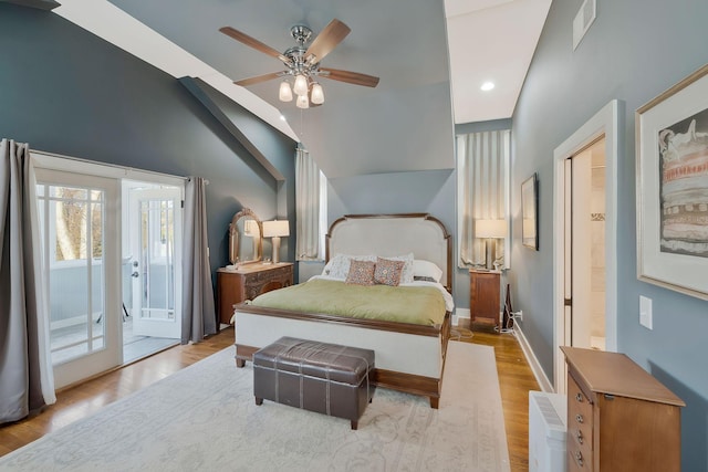 bedroom with ceiling fan, access to exterior, vaulted ceiling, light hardwood / wood-style floors, and french doors