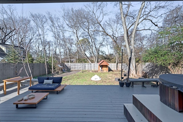 wooden deck featuring a playground and a hot tub