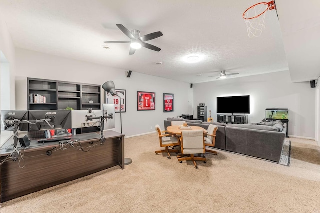 office area featuring ceiling fan, light colored carpet, and a textured ceiling