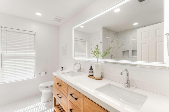 bathroom with tile patterned floors, vanity, and toilet