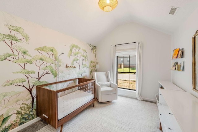 bedroom featuring light colored carpet and lofted ceiling