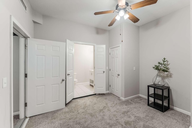 bedroom featuring ceiling fan, light carpet, and connected bathroom