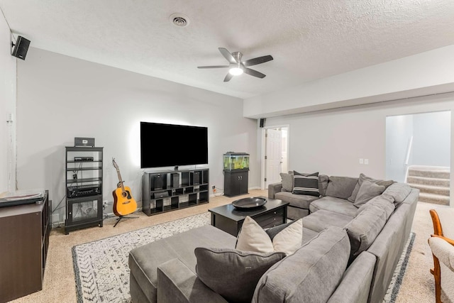 living room with a textured ceiling and ceiling fan