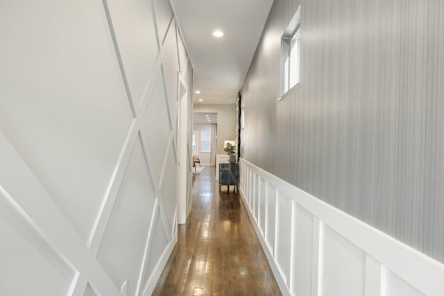 corridor with dark hardwood / wood-style flooring