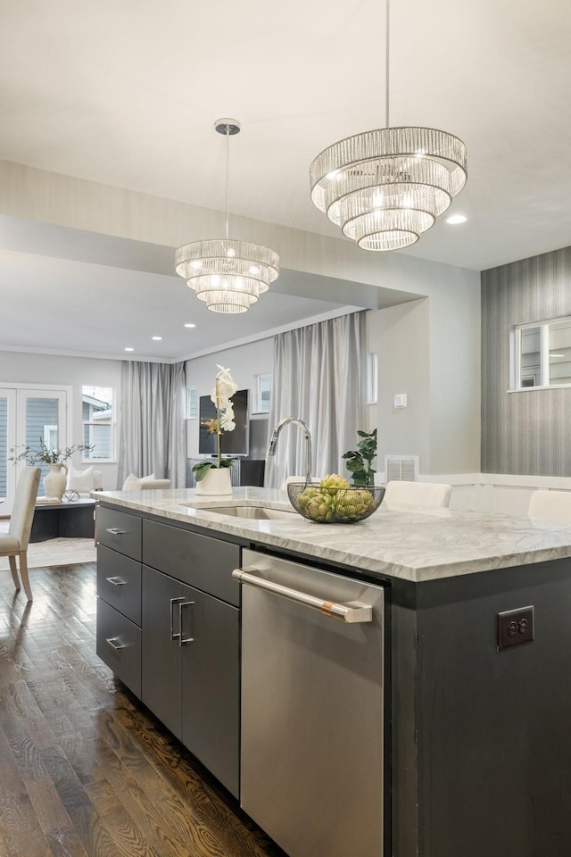 kitchen with a chandelier, dishwasher, a kitchen island, and hanging light fixtures